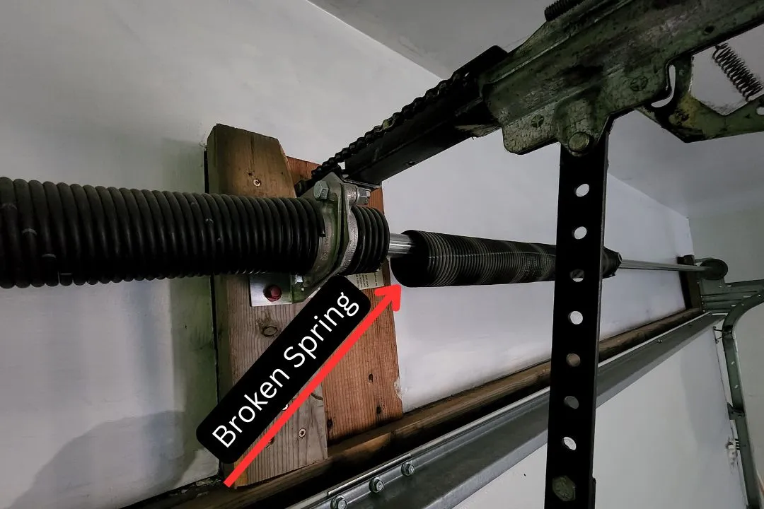 Broken garage door torsion spring marked for emergency repair in St. Albert