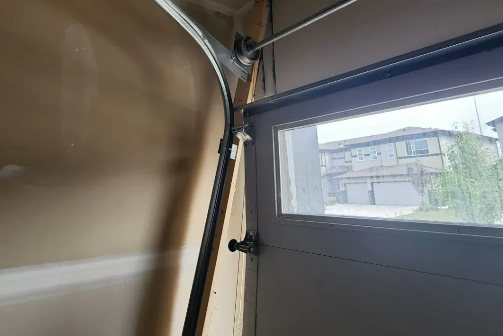 Bent garage door track and hardware alignment check during inspection
