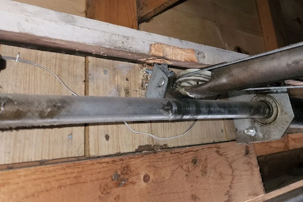 Garage door torsion spring system with signs of wear during inspection in Edmonton